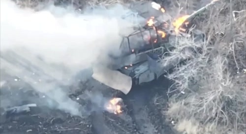 A burning crew member of a Russian T-90M Proryv jumps out of the tank..