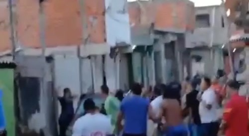 man armed with knife is brutally beaten in a favela.