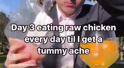 Man eats raw chicken breast for views