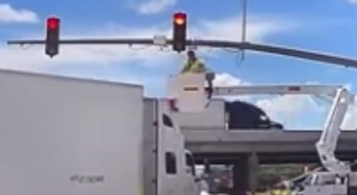 Truck hits lift with man inside