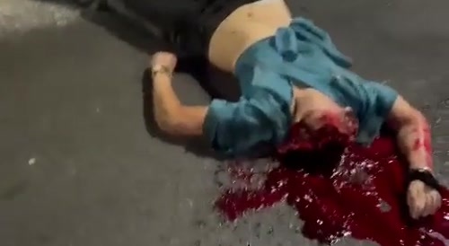 Body parts, including head are scattered around the road.