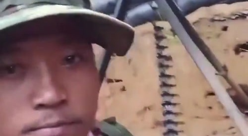 Cambodian troops fire HMG bursts at Thai positions.