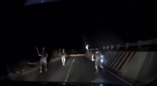 Tactical backwards driving away from a mob with machetes