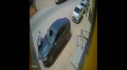 Man falls from building into car windshield...