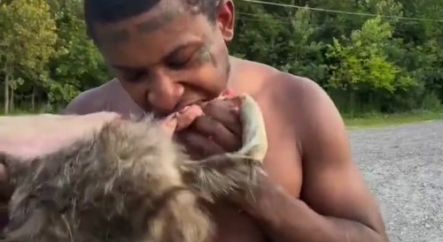A black man eating a raw animal... !