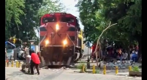 Real close : wheelchair man saved from being taken by train... !