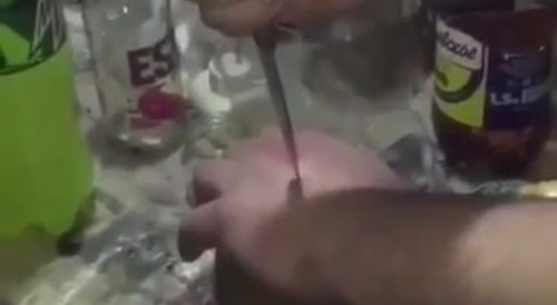 Russian drunk games : man empales his hand with knife... !