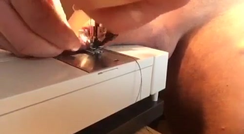 A man is sewing his penis with the sewing machine... !