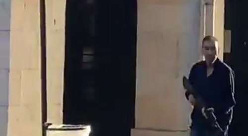 Paris by day : man walking around with a rifle...