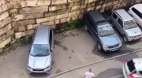 Russian woman saves her car right before wall collapses... !