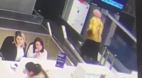 Someone goes into baggage area