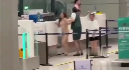 Chinese woman loses her mind and strips naked at airport.