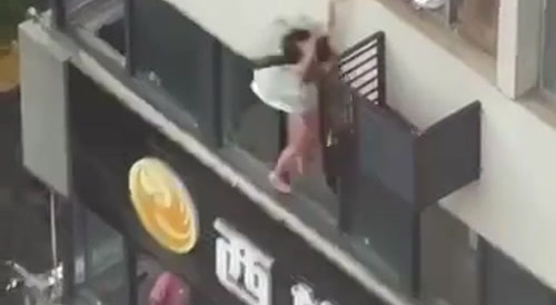 Young Asian woman's suicide jump : still arranges skirt properly after landing... !