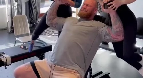 strong man lifts two women