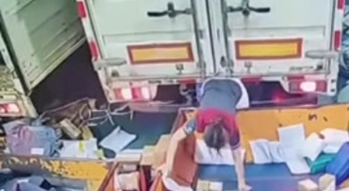 Female worker is a little squashed behind truck...