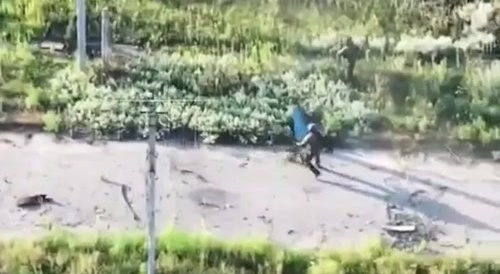 Russian soldier tries to save his comrade.