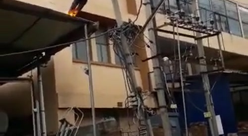 Man is touching an electrical wire...