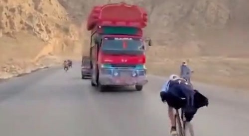 man on bicycle defies traffic with reckless driving...