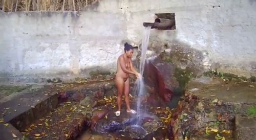 mulher tomando banho de bica