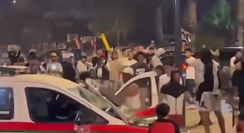 A police car was flipped upside down by protests