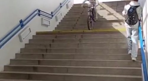 Bicyclist goes down stairs