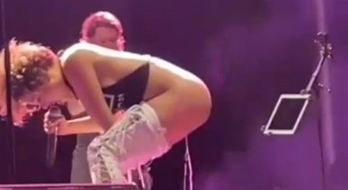 female rock singer urinates on fan during concert