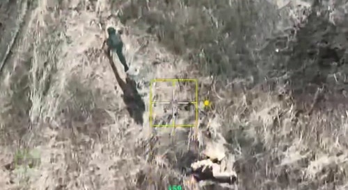 A Russian soldier finishes off wounded Ukrainians in the head.