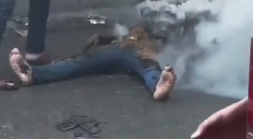 Demonstrator Hit by Smoke Grenade