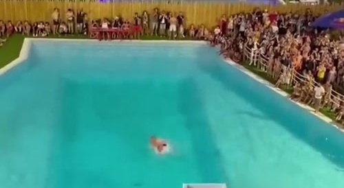 Fat man gets injured jumping off giant slide.