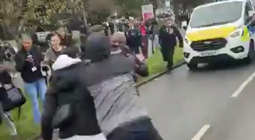 Police tackle man to stop a fight