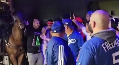 LAPD on horses charge at and beat guests standing in line