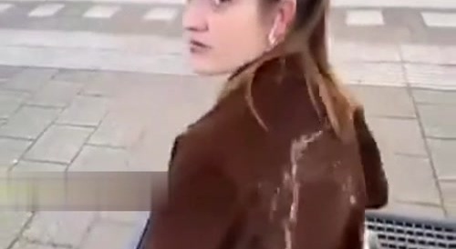 man urinates on woman in the street