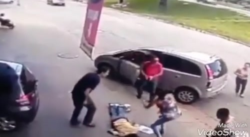 Tire hits pedestrian's head in the street.