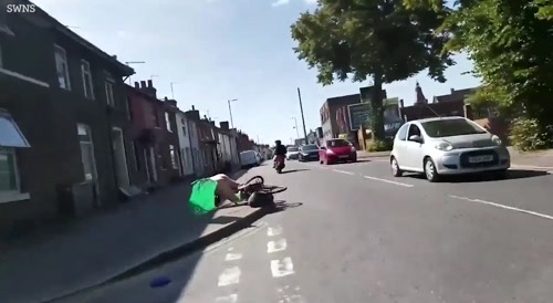 Moment thug punches naked charity cyclist off bike