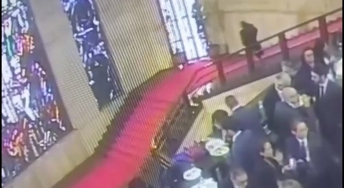 Italian politician smashes an artistic glass window with his head.