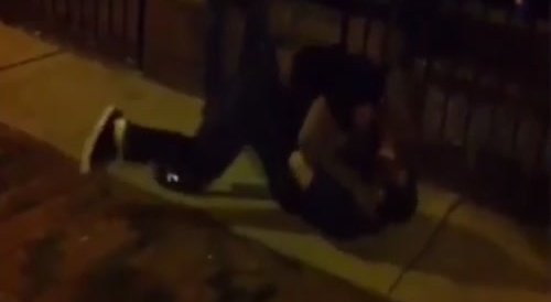 Two Men Start Fighting On The Sidewalk At Night