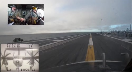E-2 landing on aircraft carrier in the rain