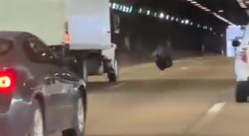Tire falls off trailer and jams back into the same area