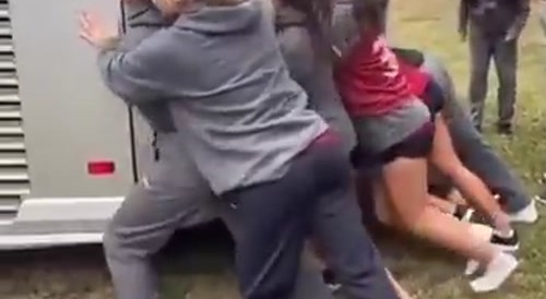 Girls push stuck bus