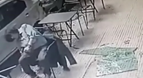 Look closely at the man sitting down.