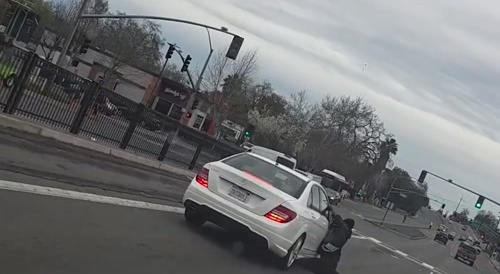 Man Hangs on to Moving Cars While Loosing Pants