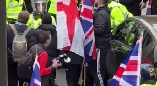 Migrant tries to attack protestors