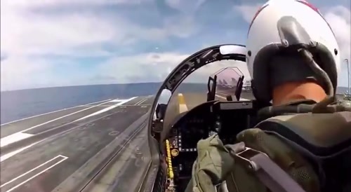 F/A-18 landing on an Aircraft Carrier after flyover