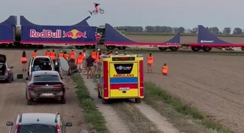 Some guy doing BMX tricks on a train with ramps