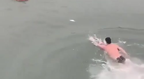 Jumps to rescue a person in  icy waters