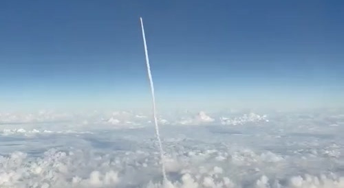 Video shows a ballistic missile flying past a passenger plane