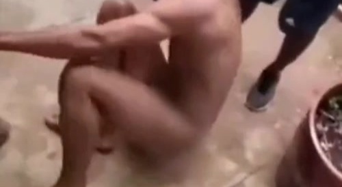 many people hitting the naked man