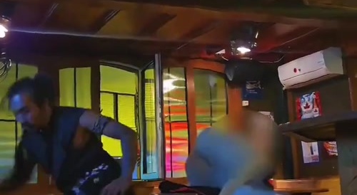 Guy does a backkick on someone at a bar