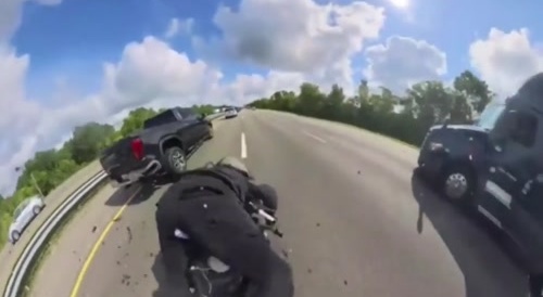 motorcyclist has an awkward encounter with a truck