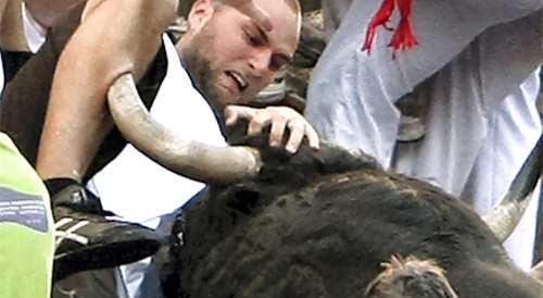 The bull gored his leg.